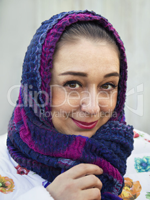 Portrait of the woman close up with a scarf on her head