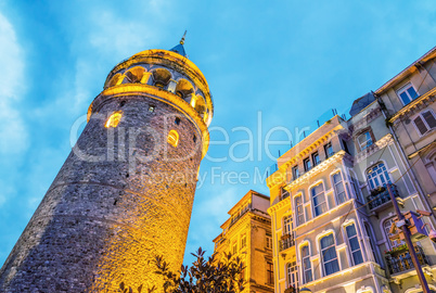 Beautiful sunset view of Galata Tower framed by street buildings
