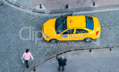 Istanbul. Taxi on a narrow ancient city street with people walki