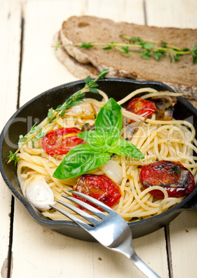 spaghetti pasta with baked cherry tomatoes and basil