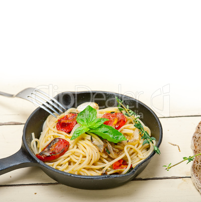 spaghetti pasta with baked cherry tomatoes and basil