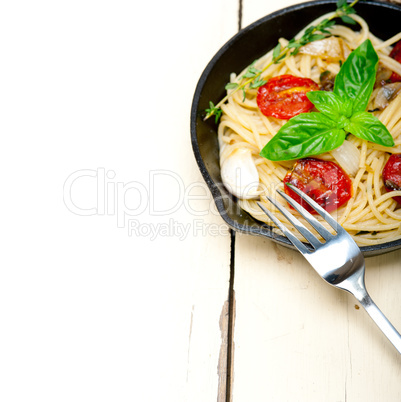 spaghetti pasta with baked cherry tomatoes and basil