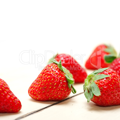 fresh organic strawberry over white wood