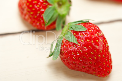 fresh organic strawberry over white wood