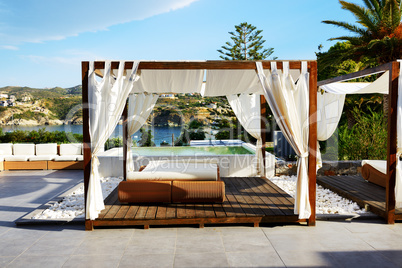 Modern hut and sunbeds at luxury hotel, Crete, Greece