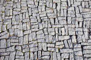 Square granite stones on the pavement background