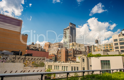 Highline Park in Manhattan with city skyline on a beautiful day