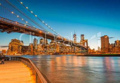 Amazing Manhattan skyline and Brooklyn Bridge after sunset with