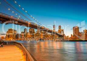 Amazing Manhattan skyline and Brooklyn Bridge after sunset with