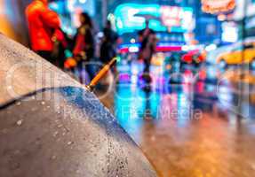 Open umbrella on a rainy night in Times Square - New York City
