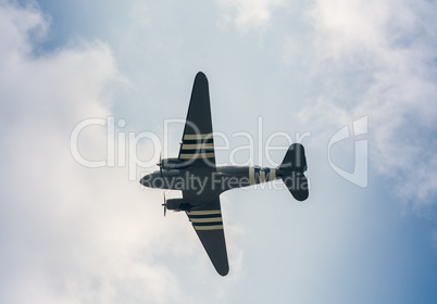 Military airplane as seen from the ground against blue sky