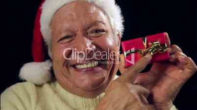 Happy Aged Man Offering A Small Red Wrapped Gift