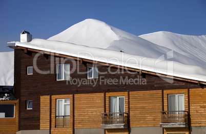 Snowy hotel in winter mountains at nice day