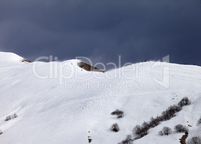 Off piste slope and overcast gray sky in windy day