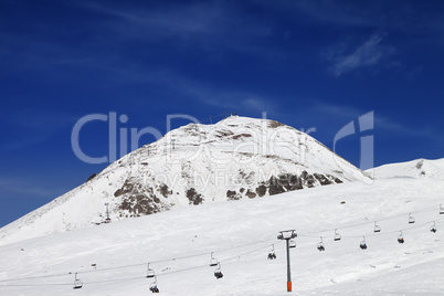 Winter mountains and ski slope at nice day