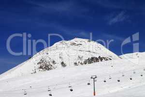 Winter mountains and ski slope at nice day