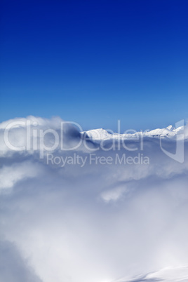 Mountains under clouds and clear sunny sky