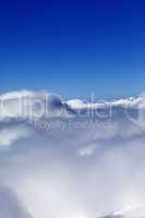Mountains under clouds and clear sunny sky