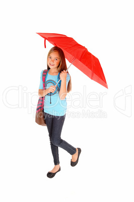 Young girl standing with umbrella.