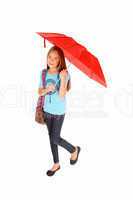 Young girl standing with umbrella.