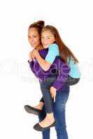 Mother piggyback daughter.