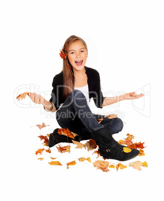 Happy girl with falling leaves.