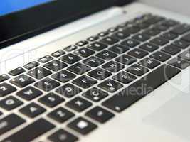 white laptop keyboard with black keys closeup