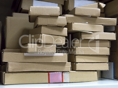 stack of small cardboard boxes on a shelf