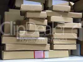stack of small cardboard boxes on a shelf