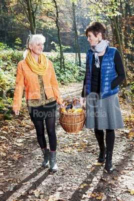 Two women wearing picnic basket