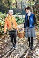 Two women wearing picnic basket