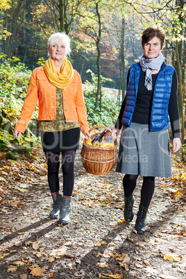 Two women wearing picnic basket