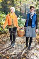 Two women wearing picnic basket