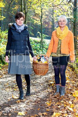 Two women wearing picnic basket