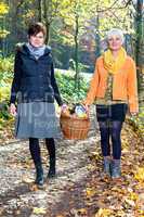 Two women wearing picnic basket