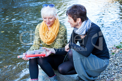 Women at the river with bottle post