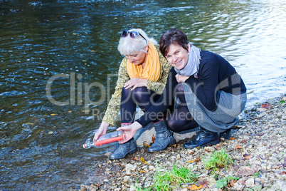 Women at the river with bottle post