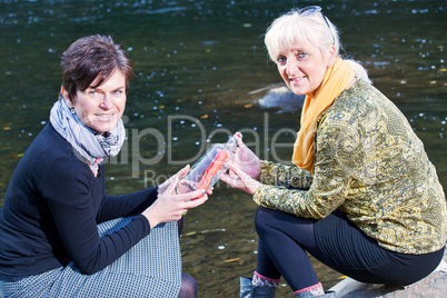 Women at the river with bottle post