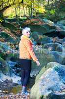 Woman alone in autumn atmosphere at the river