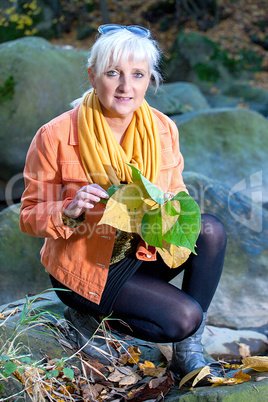 Woman alone in autumn atmosphere at the river