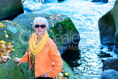 Woman alone in autumn atmosphere at the river