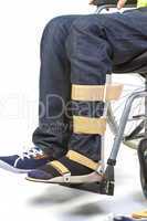 Orthopedic equipment for young man in wheelchair - close up