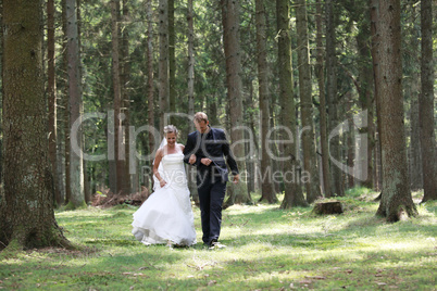 Bridal couple on forest glade