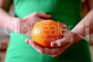 Woman holding orange