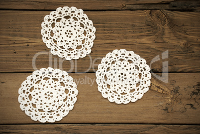 Three White Round Place Mat On Wooden Background
