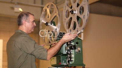 Film Technician Projecting 16mm Film