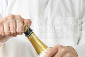 Waiter opening a botle of Champagne