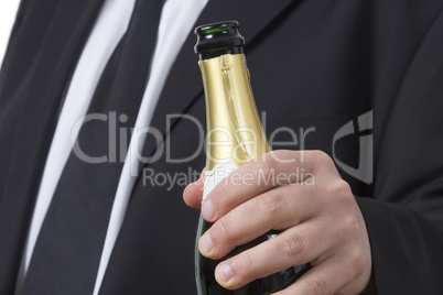 Man in suit with open Champagne bottle