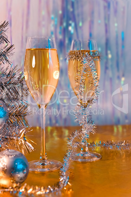 Glasses with wine, tinsel, Christmas tree and toys