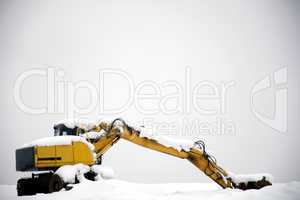 Hydraulic excavator covered with snow and not operating
